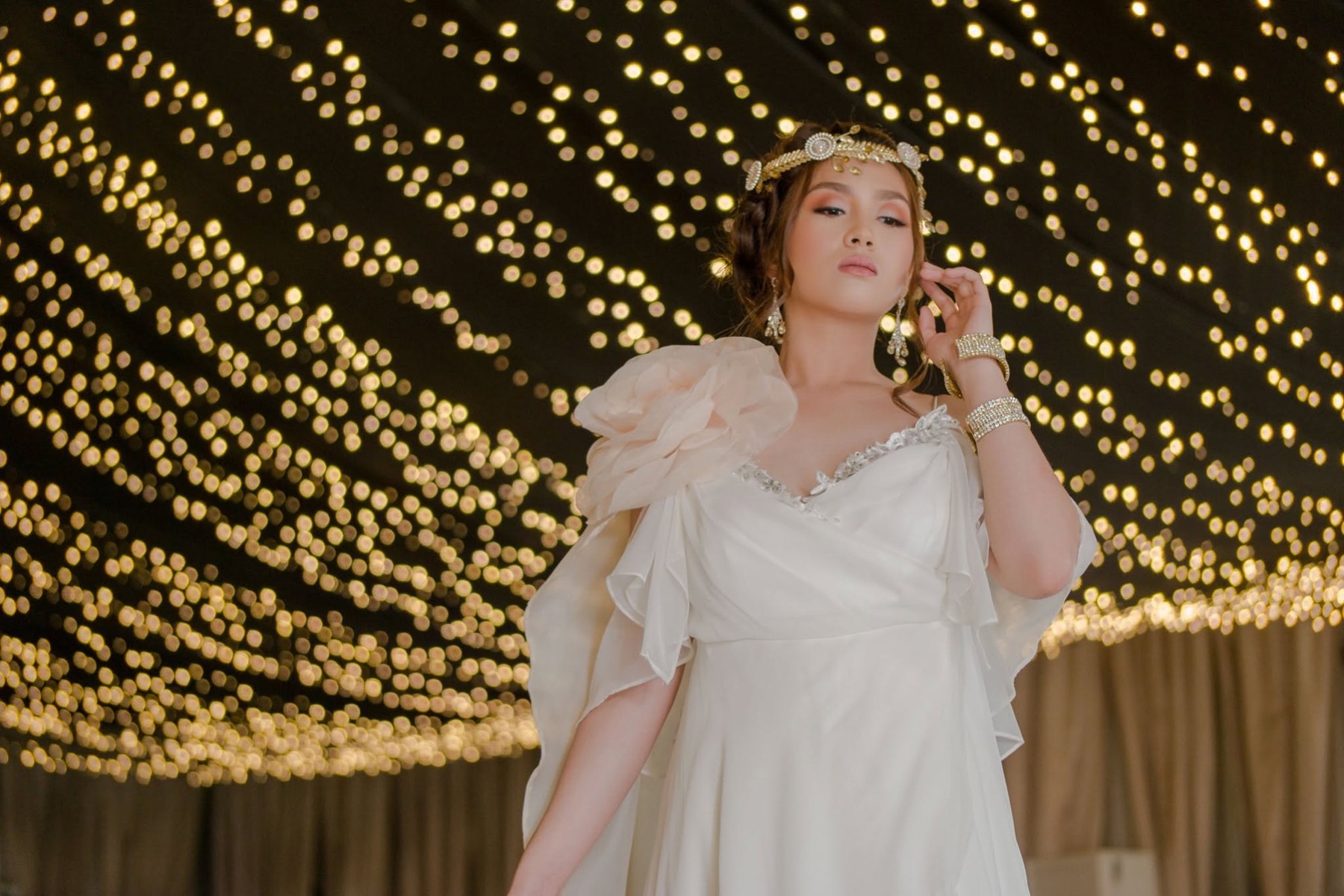 Sophia beneath a canopy of golden fairy lights