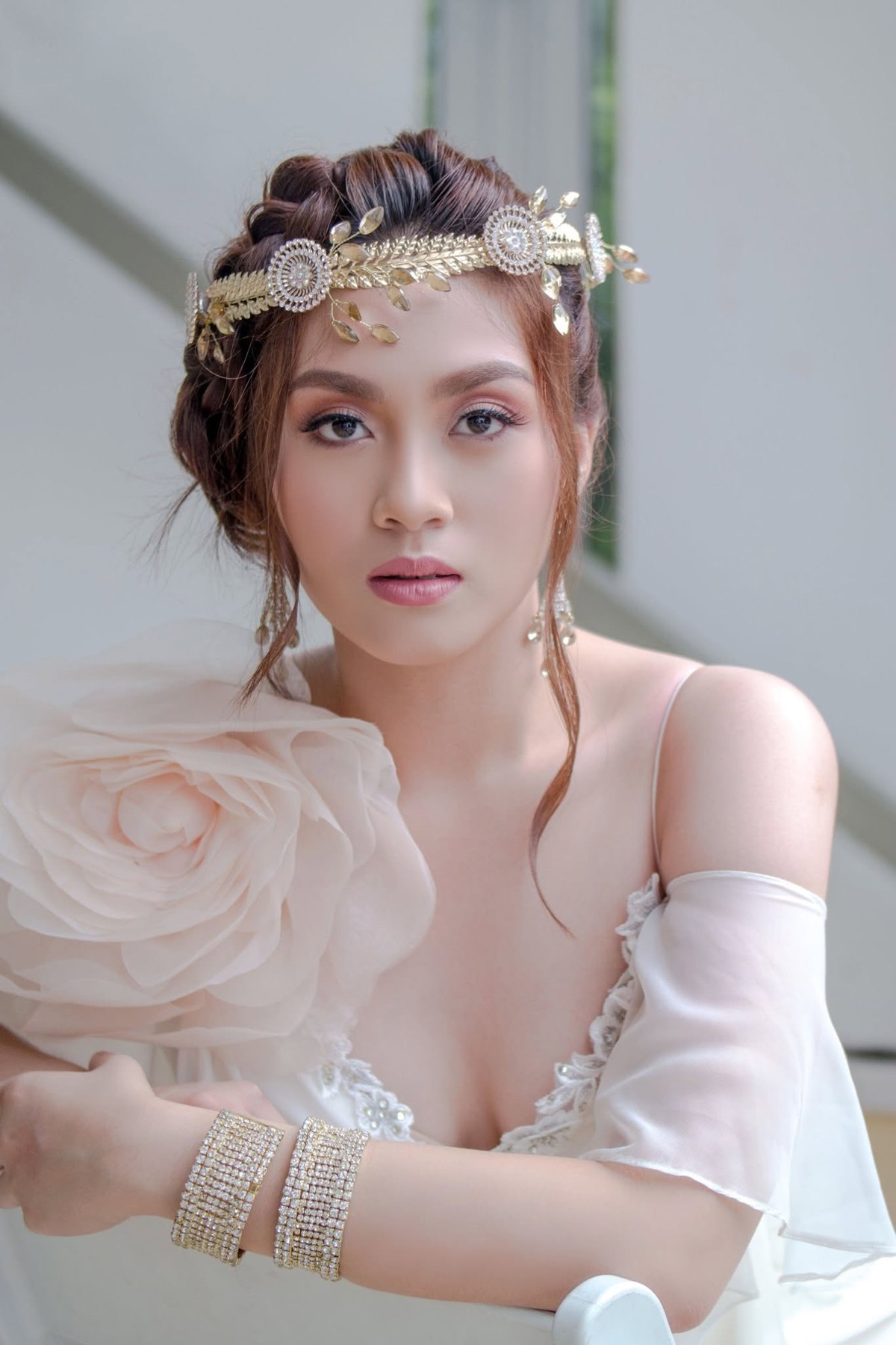 Sophia wearing a floral crown and an ivory gown