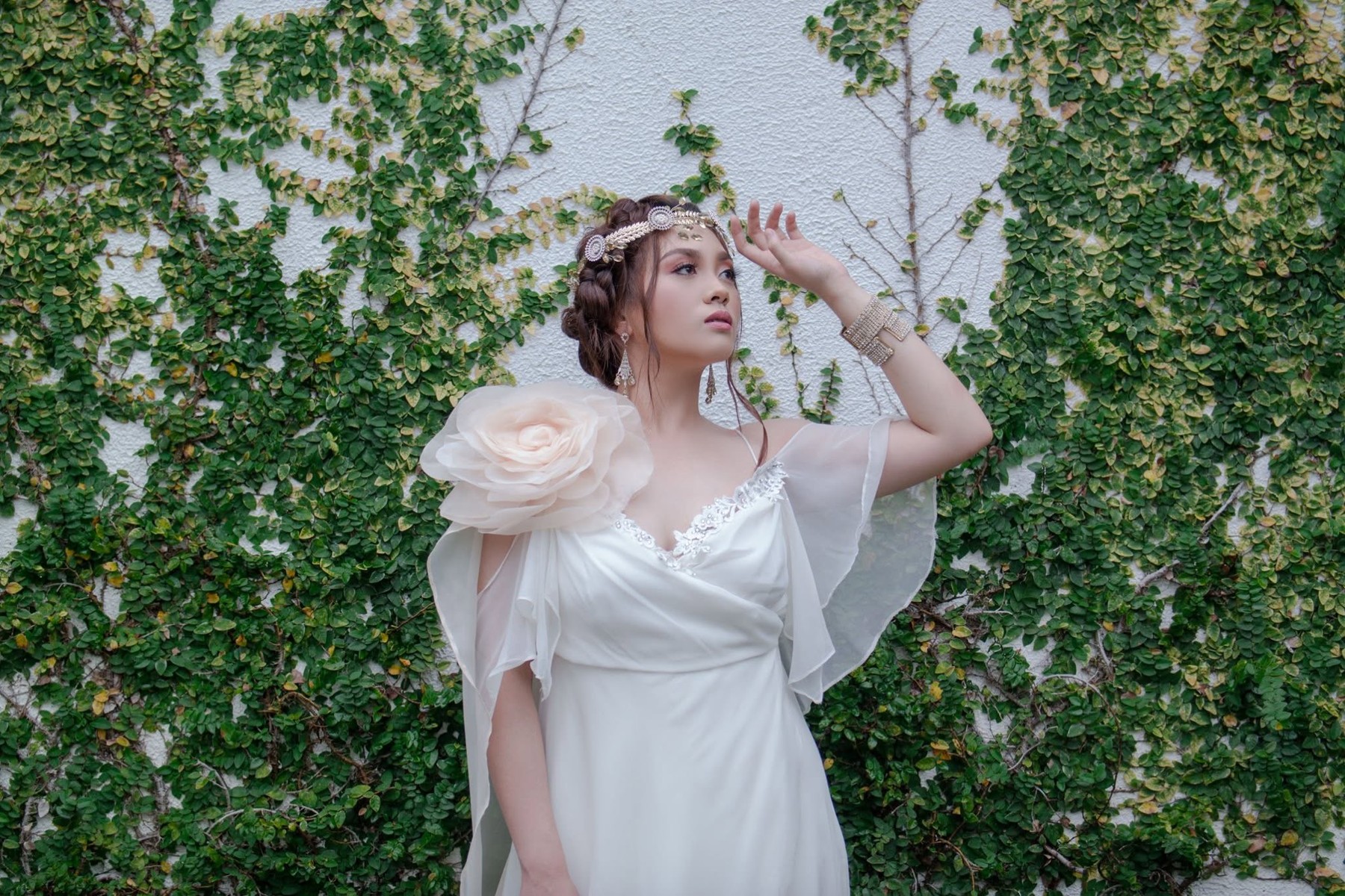 Sophia in an ivory dress in a green garden